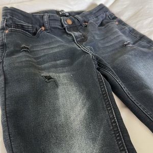 Boys distressed black stretchy denim jeans.